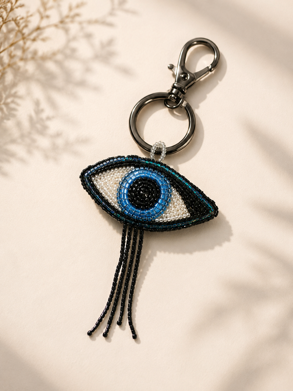 Beaded evil-eye charm in blue, white & teal