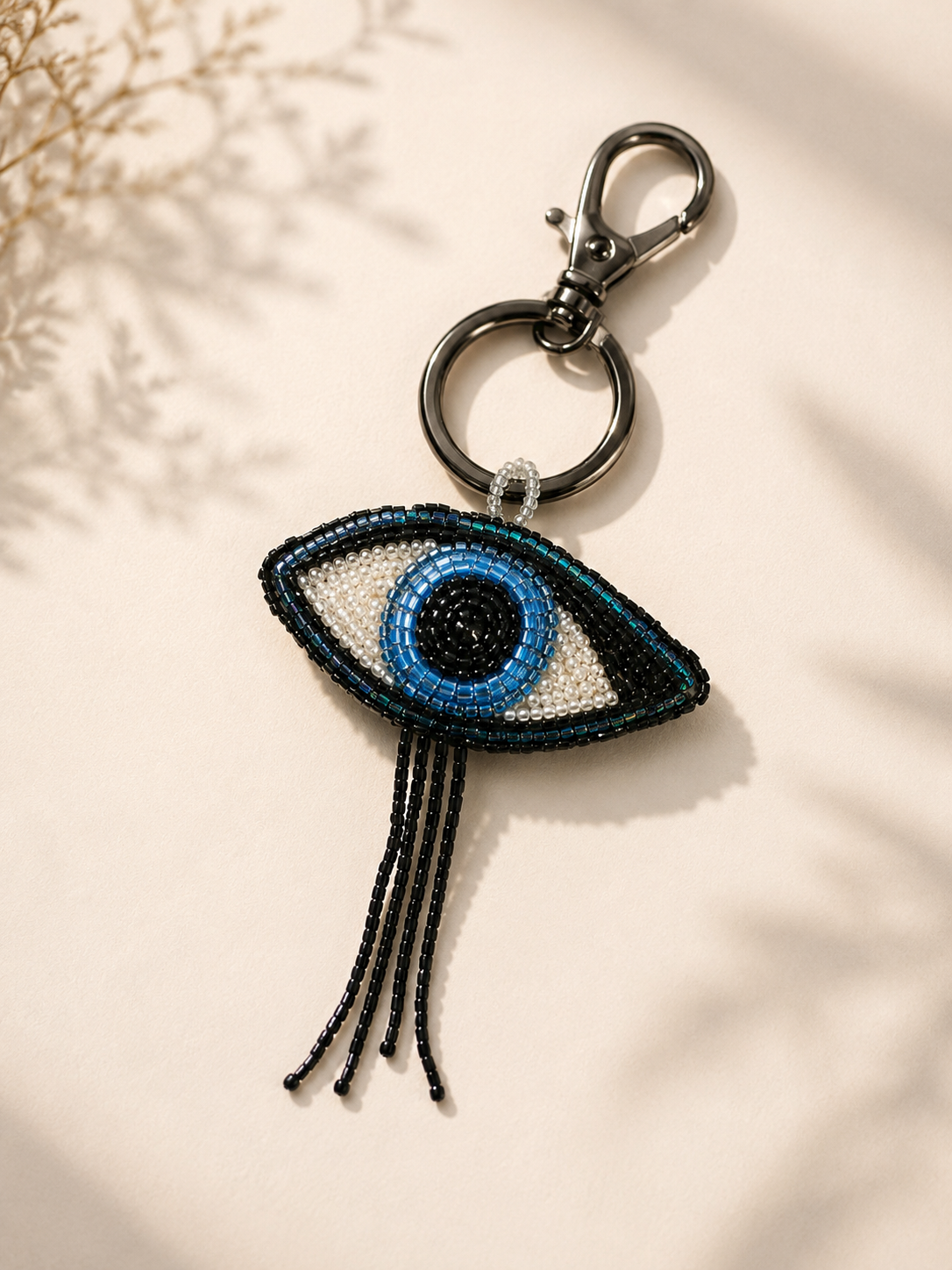 Beaded evil-eye charm in blue, white & teal
