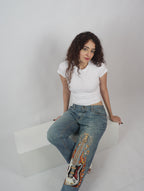 Burning Strings Denim front view – embroidered flame denim jeans