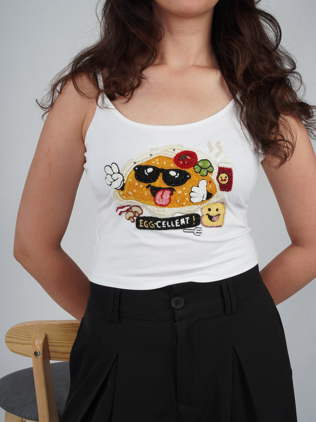 EGGZAA Top white top showcasing detailed hand-embroidered artwork