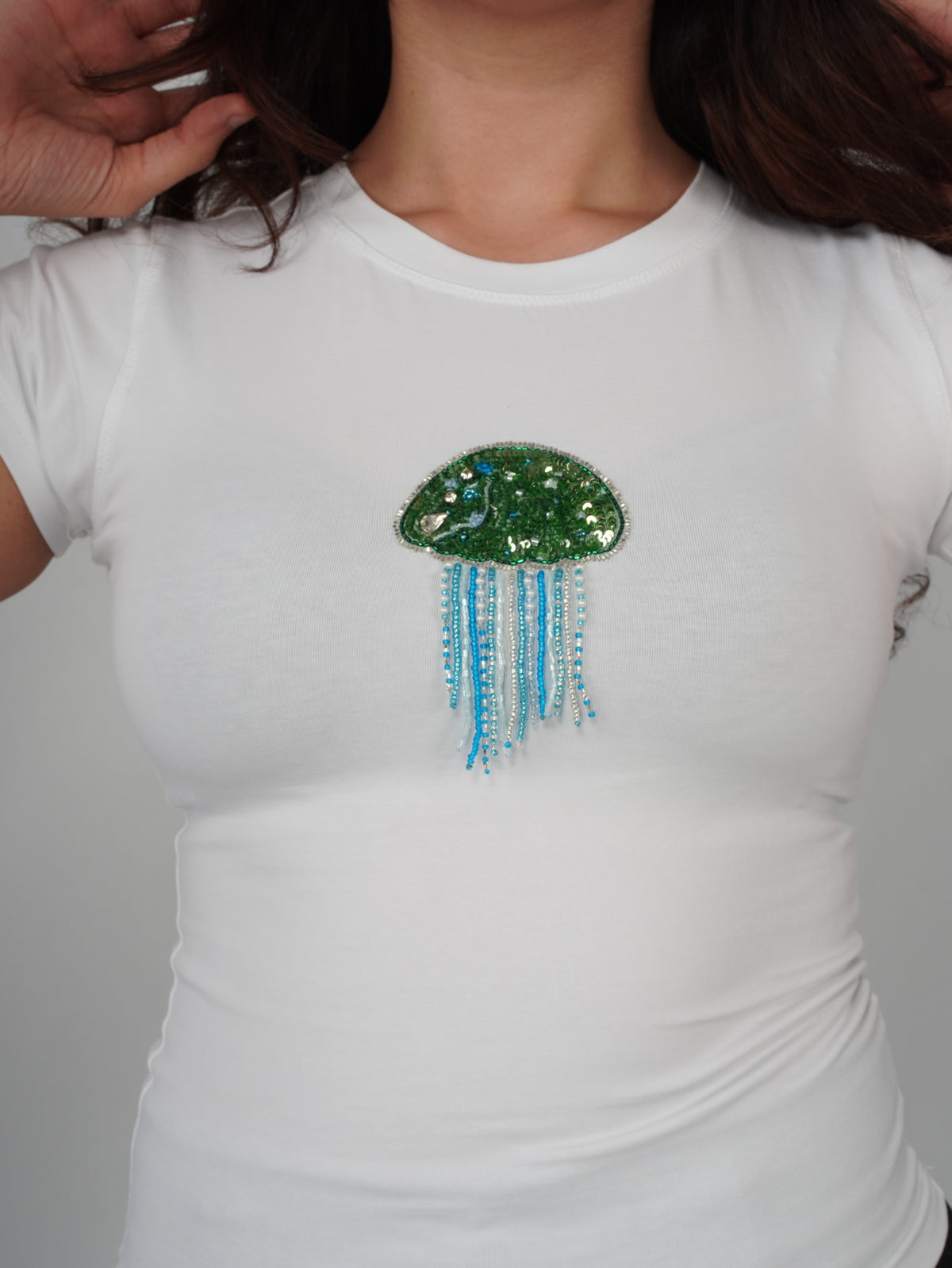 Close-up of hand-stitched embroidery on the white Jellara Top