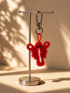 Lobster charm hanging from silver-tone clasp