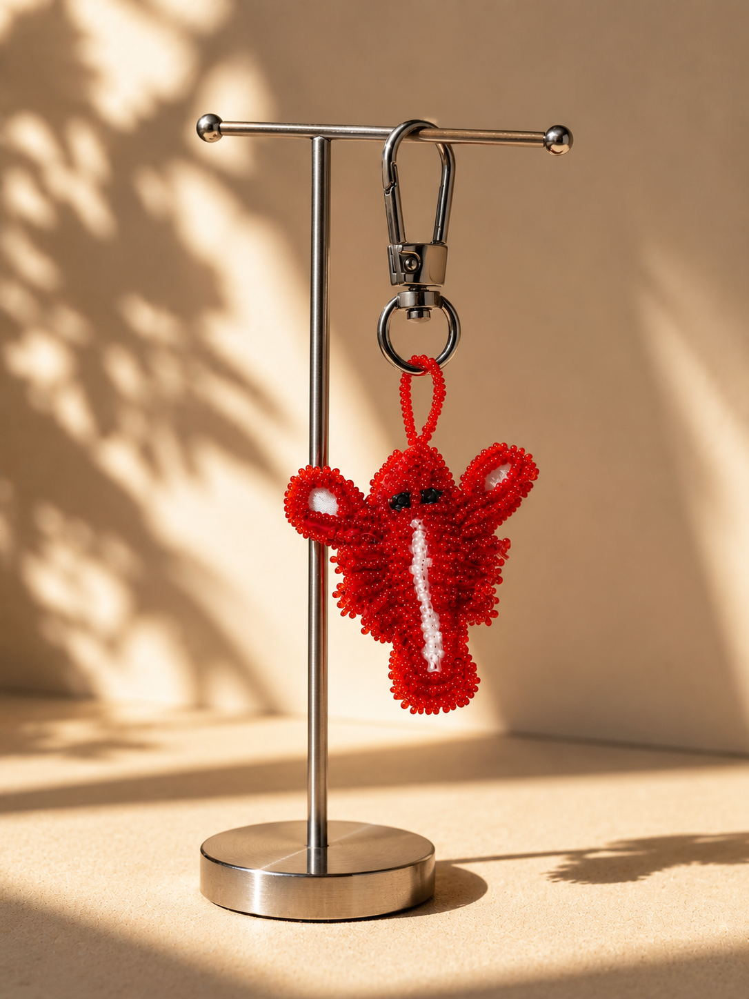 Lobster charm hanging from silver-tone clasp