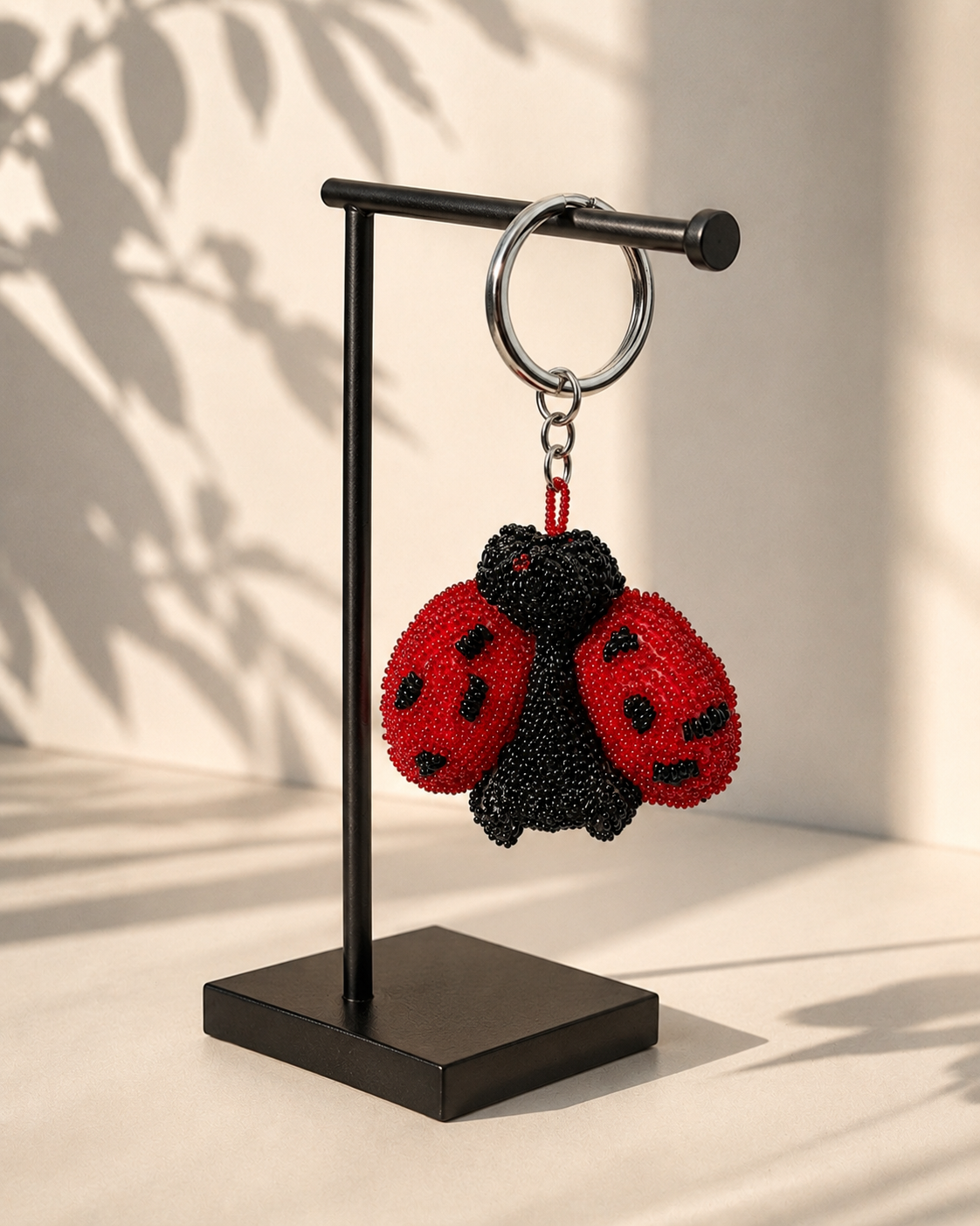 Ladybug charm hanging from silver-tone clasp