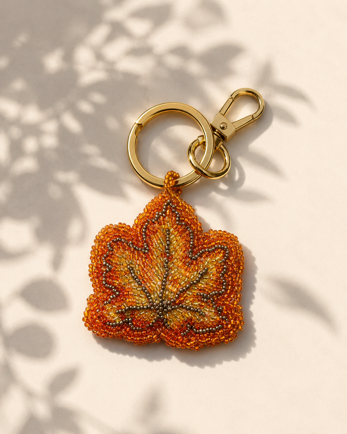 Beaded autumn leaf charm in orange, amber & gold