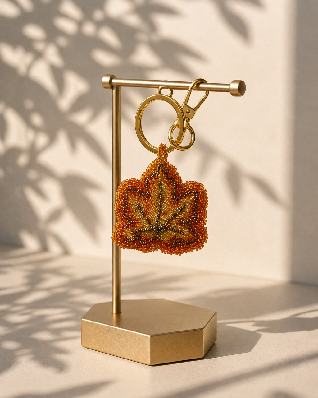 Leaf charm hanging from silver-tone clasp