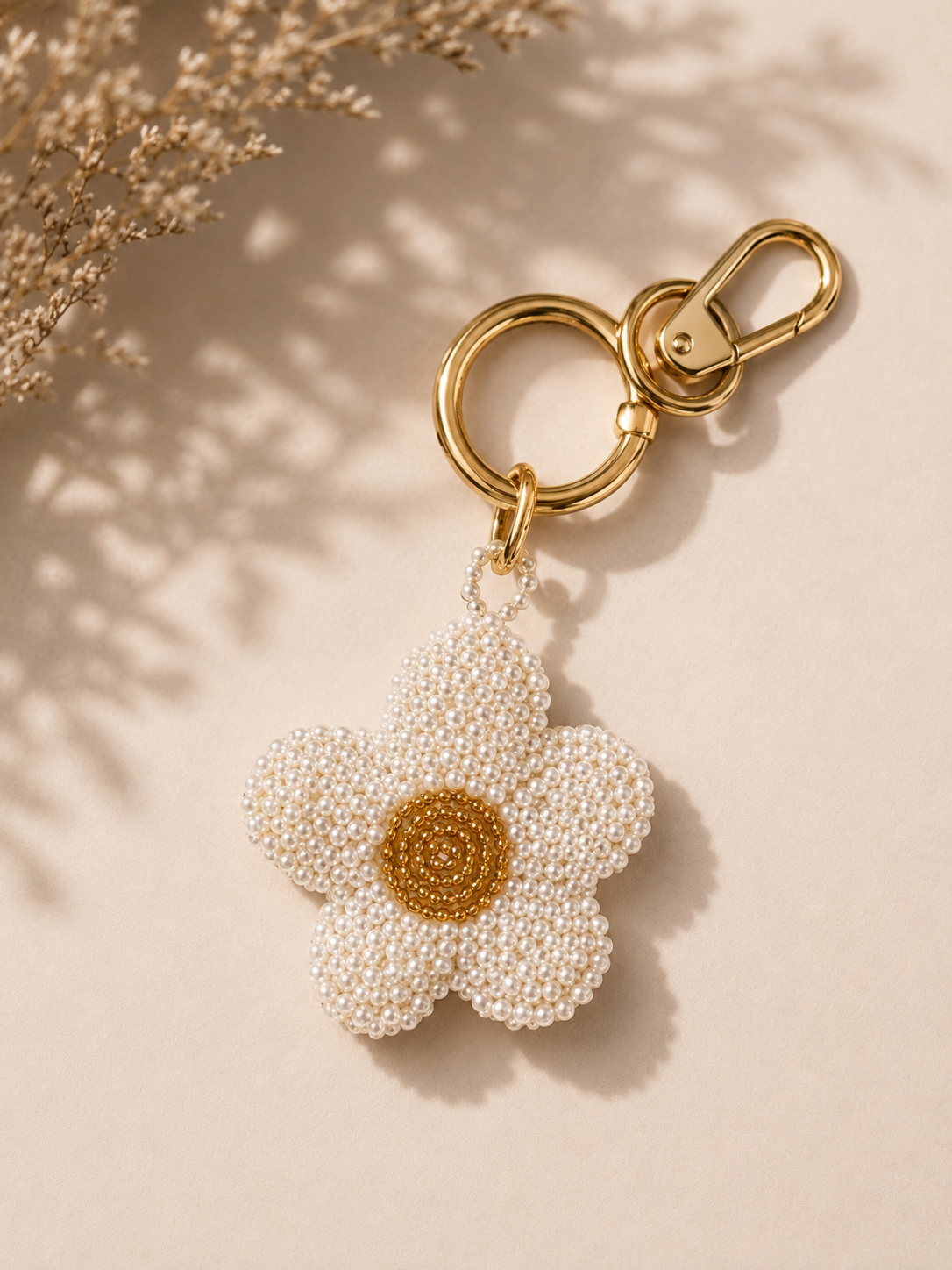 Pearl-beaded daisy charm with golden center