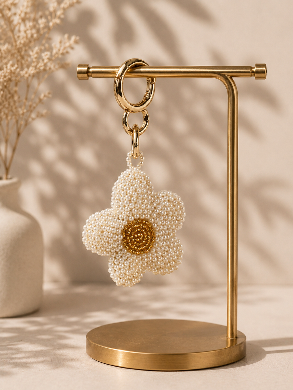 Daisy charm hanging from silver-tone clasp