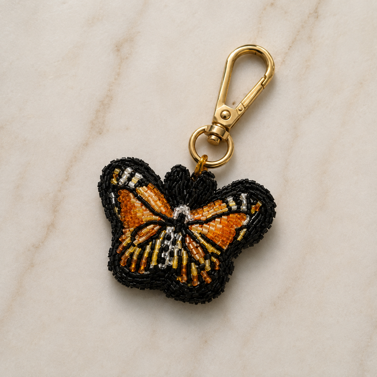 Beaded butterfly charm in amber, gold & black