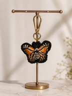 Butterfly charm hanging from silver-tone clasp