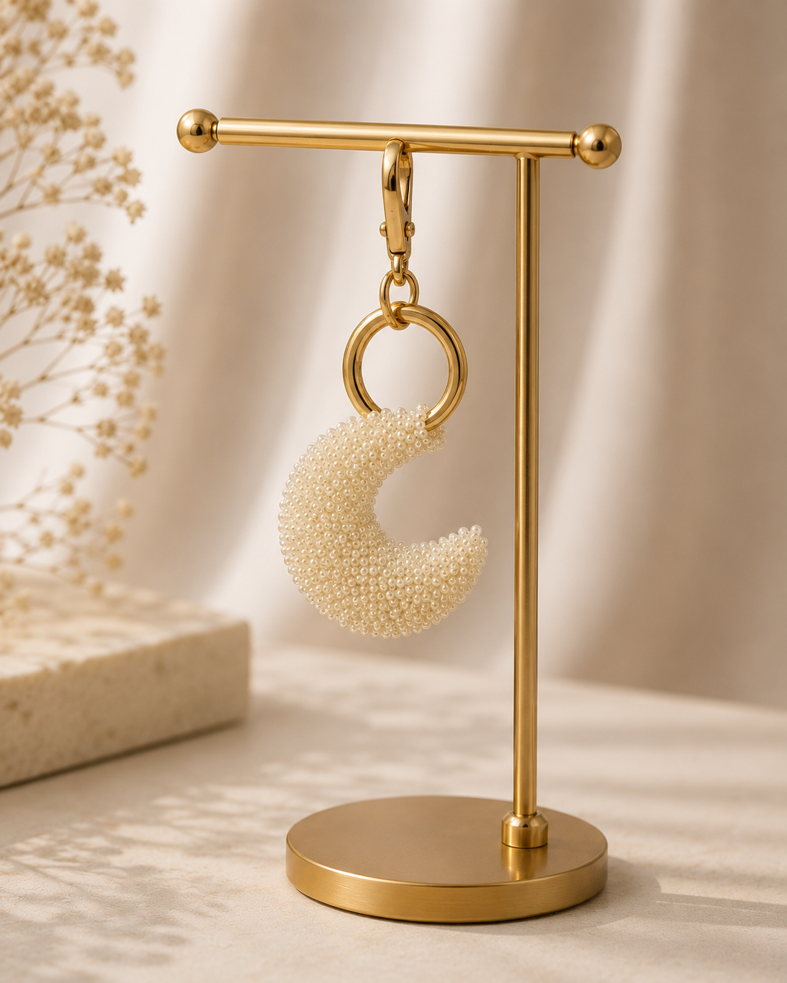 Moon charm standing upright, silver-tone clasp