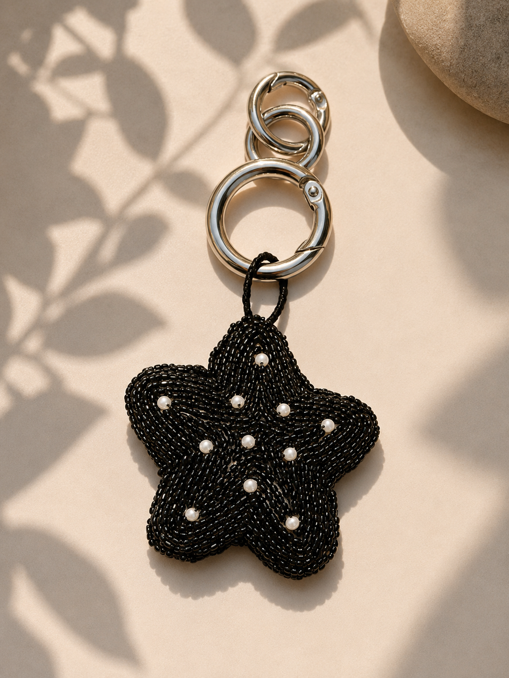 Black beaded star charm with pearl accents