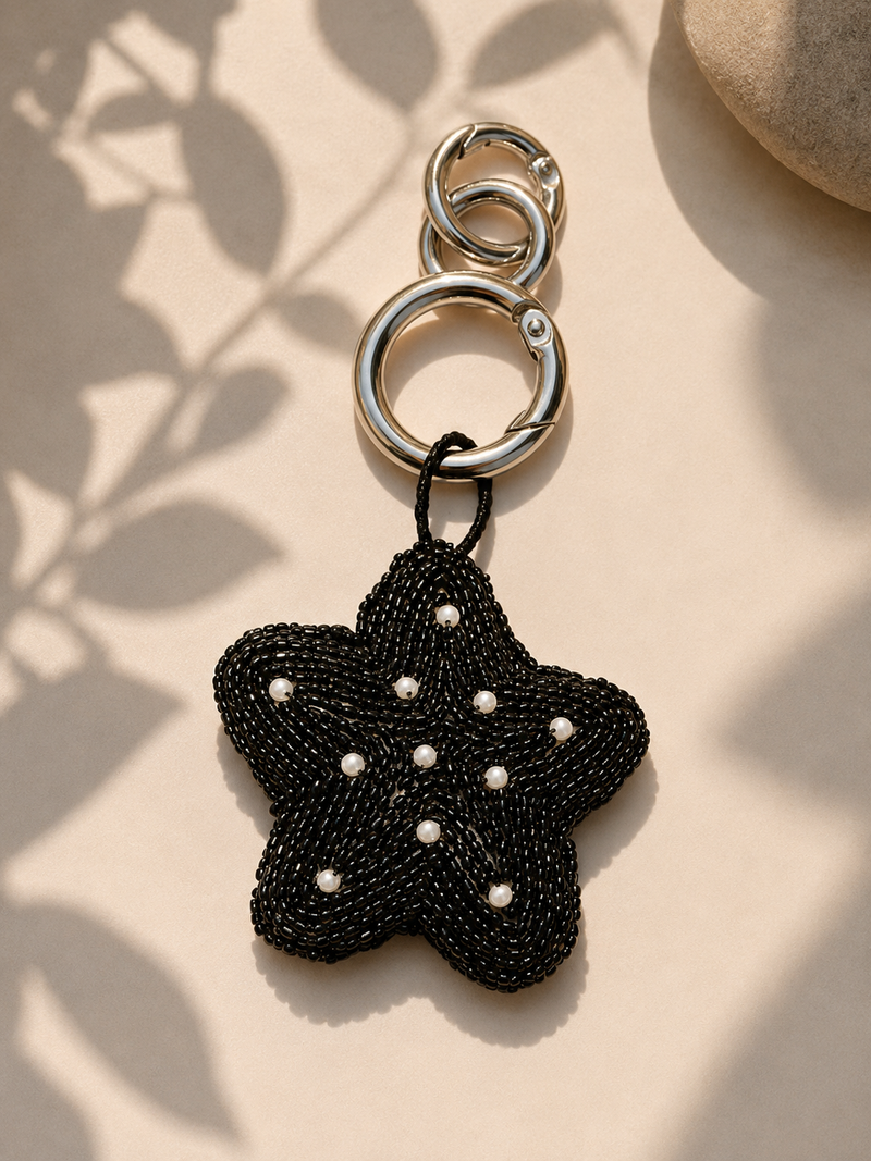 Black beaded star charm with pearl accents