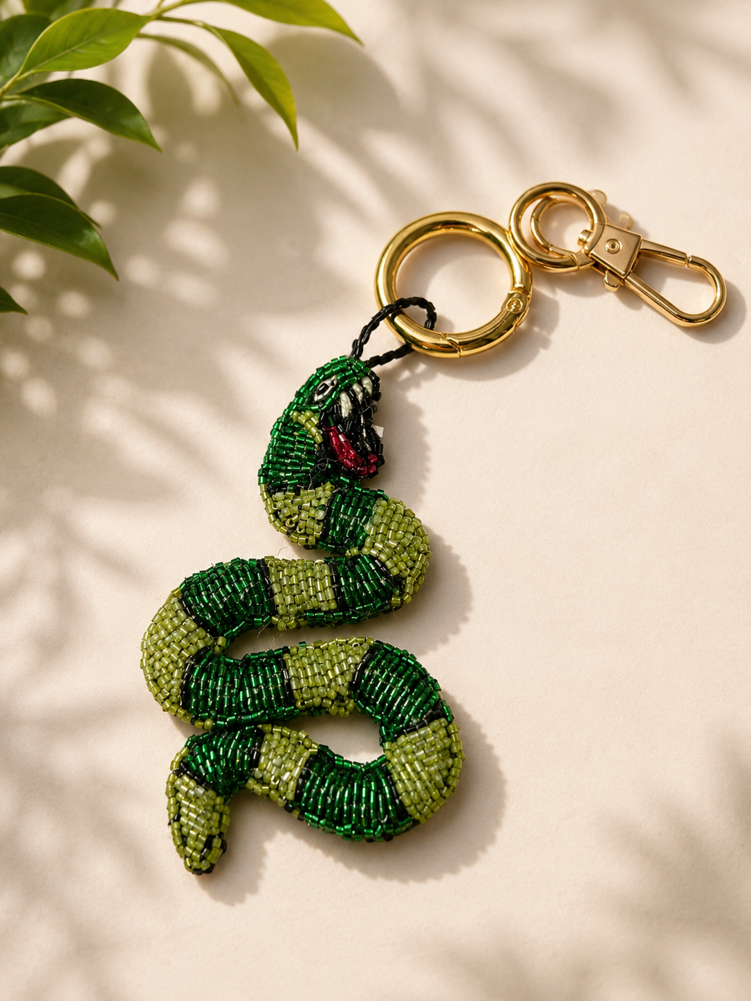 Beaded green snake charm with red mouth