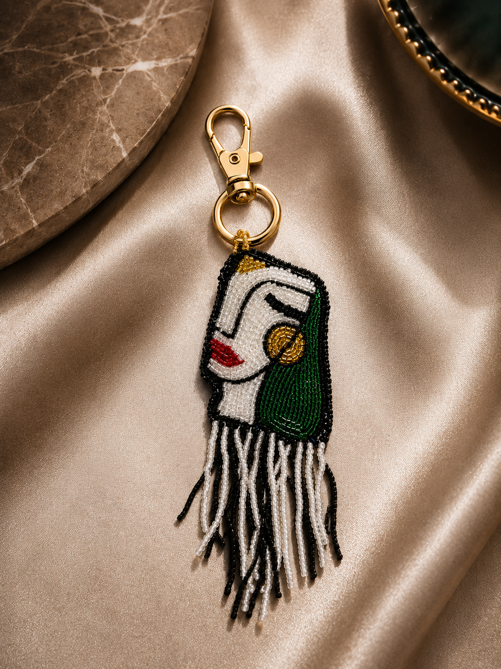 Beaded abstract face charm with black fringe