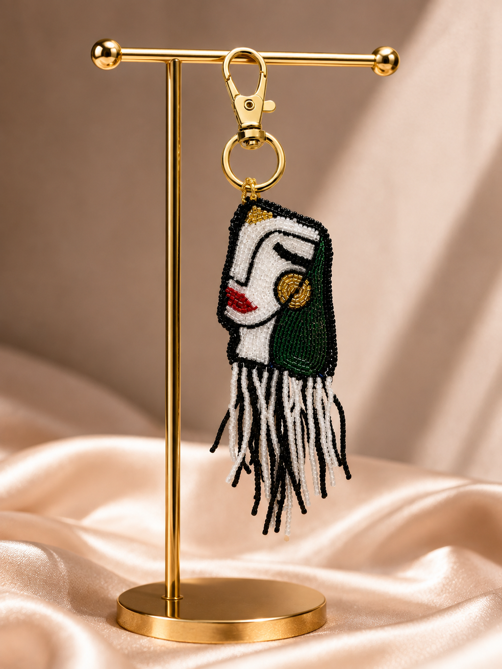 Oracle charm hanging from golden-tone clasp